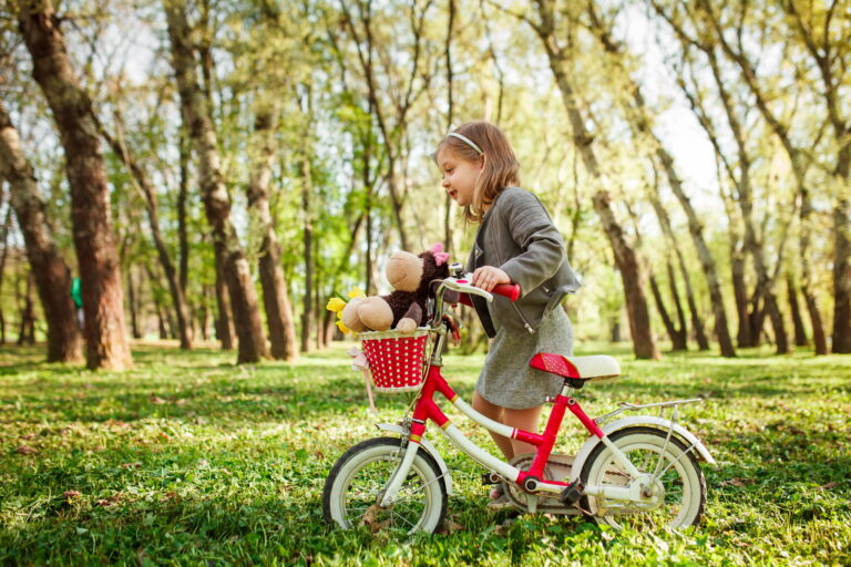 Little girl with cycle in park