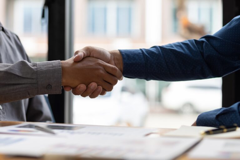 Business handshake and business men wear casual office wear.
