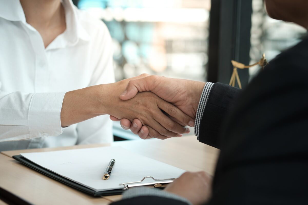 Lawyer handshake with client. Business partnership meeting successful concept.